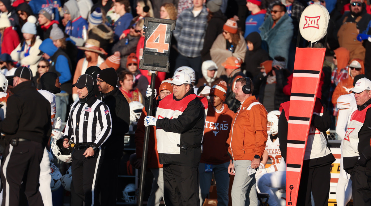 A college football chain gang holds the sticks